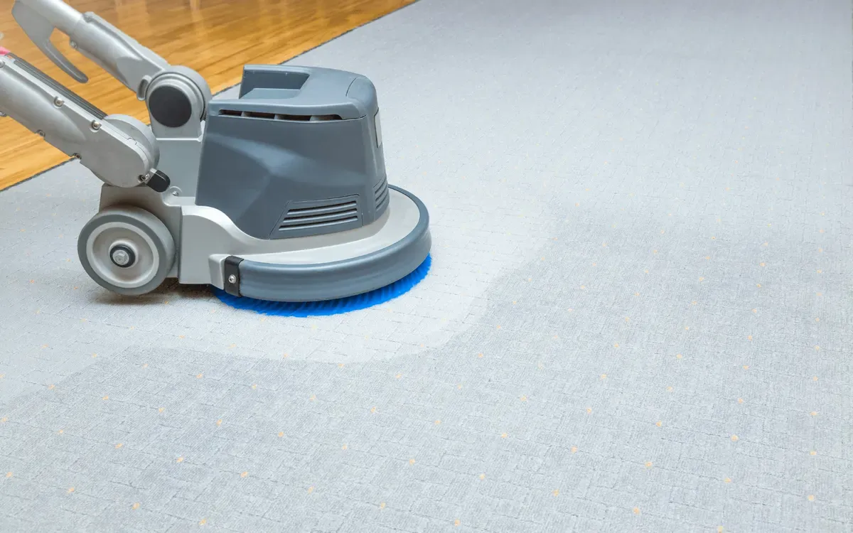 Carpet deep cleaning with industrial floor scrubbing machine.