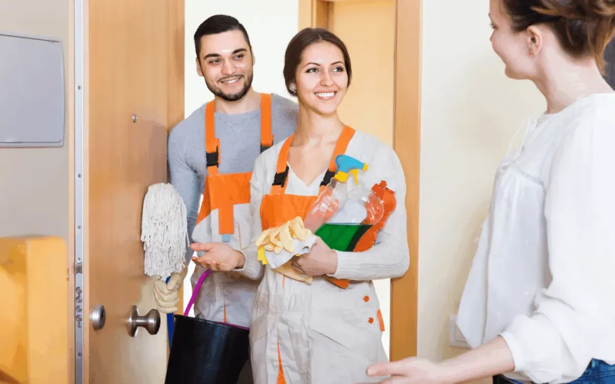 Professional cleaning team arriving with cleaning equipment and supplies for home cleaning service.
